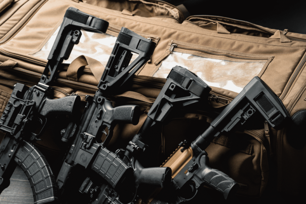 SB Tactical stabilizing braces on firearms arranged on a tan range bag