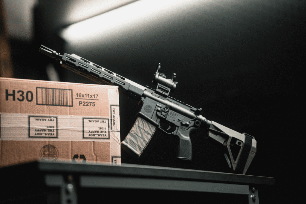 A firearm fitted with an SB Tactical brace resting on a workbench